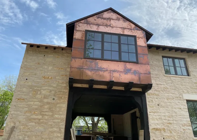 Copper metal panel facade on a stone building for Skylight Installation in Jamestown